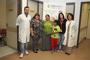Standing by younger patients from the “Smile of the Child” 